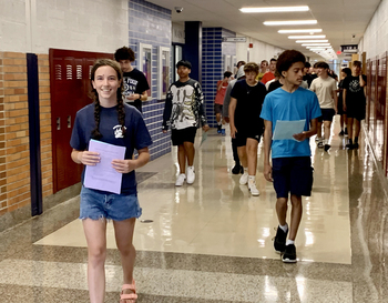 A group of students of mixed races walk down the hallway at Berkley High School.