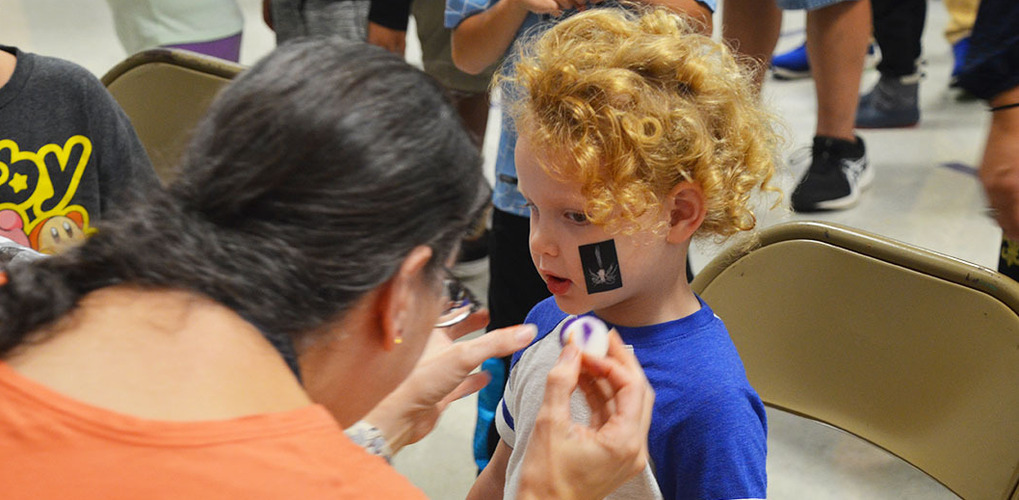 Berkley Building Blocks student getting face paint put on a the Fall Festival