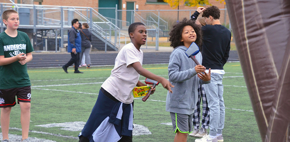 Anderson students throwing inflatable axes at the Viking Fest