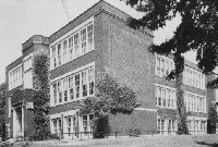 Angell 1927 - 3 story brick building that is T shaped.